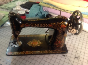 1911 Singer, converted to an electronic model by the original owner. It was found in the dusty corner of a thrift store for $65. I have since found the parts to convert it back to it's original hand crank format. Now all it needs is a bed and a cleaning!